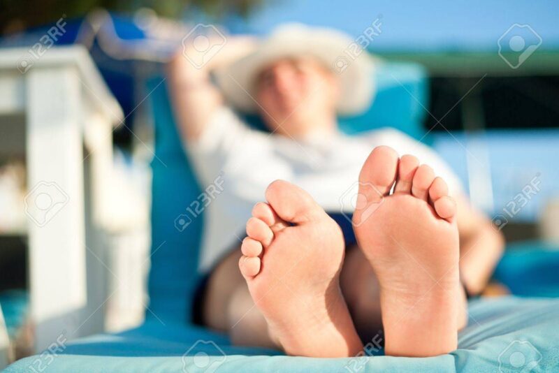 14529174-mature-woman-feet-relaxing-on-the-beach-during-tropical-vacation